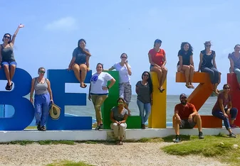 people around a Belize Sign